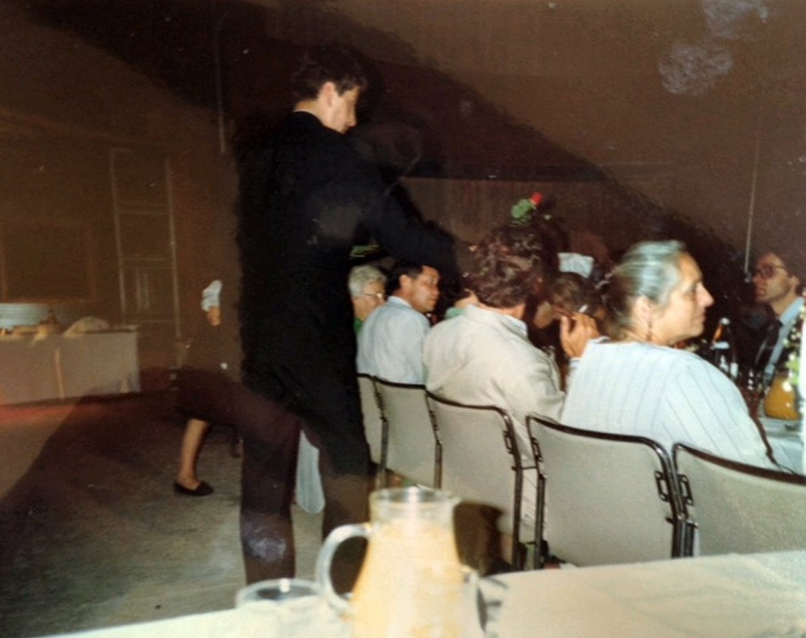 A waiter distributes roses for the ladies at a dinner at Anugraha